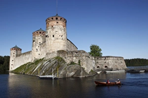 Images Dated 21st June 2009: Girls relaxing beside Olavinlinna Medieval Castle (St. Olafs Castle)