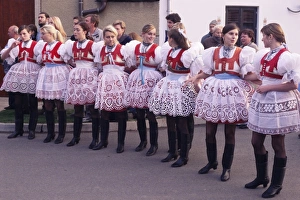 Adolescent Prints: Girls in traditional dress lined up during ceremony, Dress Feast with Wreath