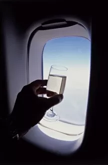 Images Dated 6th November 2009: Glass of champagne at 30000 feet and aircraft window