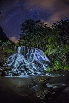 Spiral Galaxy Prints: A glowing waterfall at night with the Milky Way above, Kapaa, Hawaii
