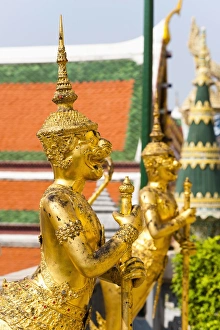 Stereotypically Thai Prints: Two gold guardian statues, at the Grand Palace, Bangkok, Thailand, Southeast Asia, Asia
