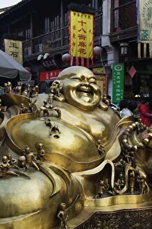 Images Dated 6th January 2008: A golden statue of a reclining laughing Buddha covered in small Buddhas