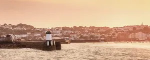 Maritime Prints: Golden sunset view of Castle Pier Lighthouse and harbor in Saint Peter Port, Guernsey