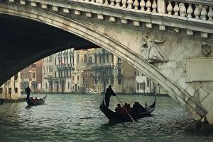 Gondola under the Rialto Bridge on the Grand Canal in Venice