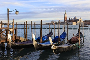 Gondolas, San Marco waterfront at sunset in winter, view to San Giorgio Maggiore