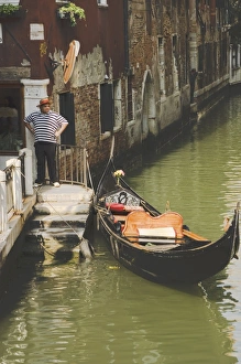 Gondolier Prints: Gondolier and gondola for hire on canal