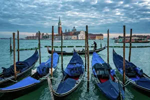 Iconic Landmark Prints: Gondolier paddling a gondola with San Giorgio Maggiore island and Basilica in the background at sunset
