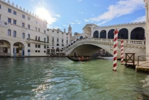 Gondola Prints: A gondolier rowing under Rialto Bridge in Venice, UNESCO World Heritage Site, Veneto