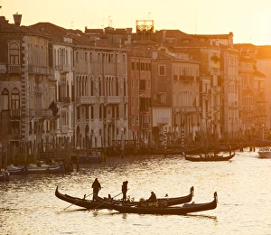 Grand Canal Prints: Two gondoliers in silhouette at sunset on the Grand Canal, from Rialto Bridge, Venice