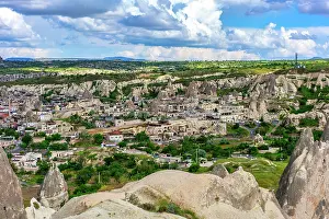 Cappadocia Prints: Goreme town in Cappadocia Turkey with Rocket Valley rock formations in the background during daytime