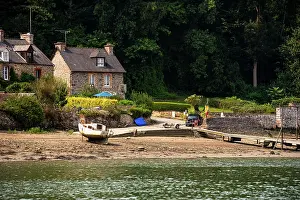 Docked Prints: Granite cottages and slipway at a hamlet on the Rance estuary in Brittany France during daylight