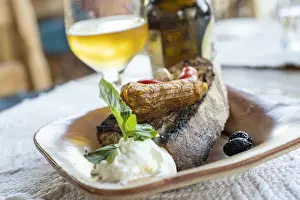 Beer Prints: Greek appetizer of stuffed zucchini flowers served with bruschetta and tzatziki sauce in wood bowl