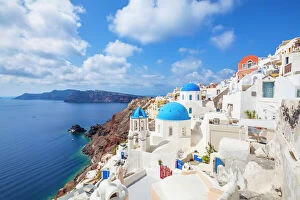 Typically Greek Gallery: Greek church with three blue domes in the village of Oia, Santorini (Thira), Cyclades Islands