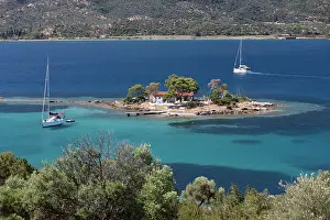 Anchor Prints: Greek Orthodox church on small island with anchored yacht off Russian Bay with crystal clear turquoise water