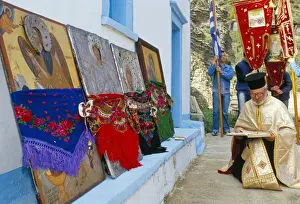 Festivity Prints: Greek Orthodox priest praying during Lambri Triti festival