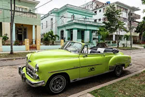 Vintage Car Prints: Green open top Chevrolet classic car parked in suburb