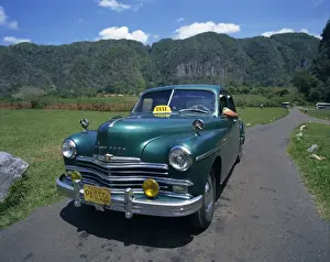 Vinales Prints: A green Plymouth taxi, a classic pre-Castro American car, in Two Sisters Valley