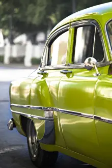 Vintage Car Prints: Green vintage American car parked on a street in Havana Centro
