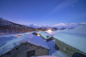 Groppera stone huts covered with snow during a starry night, Madesimo, Valchiavenna