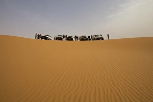 Fezzan Desert Prints: A group of 4x4 vehicles in the dunes of the erg of Murzuk in the Fezzan desert
