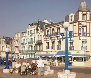 Senior Prints: Group of elderly people sitting on seafront in the restort town of Mers les Bains