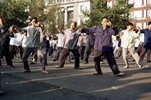 Keep Fit Prints: A group of men and women doing tai-chi exercises in the open air on the Bund in Shanghai