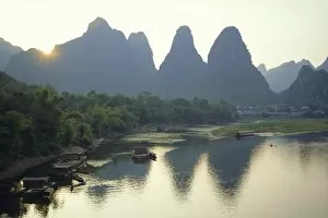 River Side Collection: In Guilin limestone tower hills rise steeply above the Li River, Yangshuo