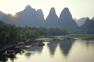 L Imestone Prints: In Guilin limestone tower hills rise steeply above the Li River, Yangshuo