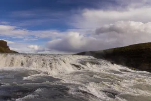 Waterfalls Prints: Gullfoss waterfalls upper cascade in South Iceland with rushing water and a cloudy sky
