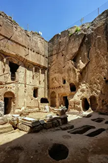 Settlement Prints: Gumusler ancient monastery features carved caves and rock formations in Turkey's historical landscape