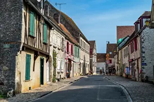 Photographer Prints: Half timbered houses display old architecture in Provins France with a quiet street background