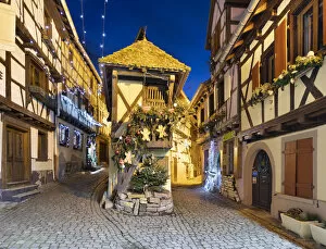 Celebration Gallery: Half-timbered houses along Rue du Rempart Sud lit up with Christmas decorations at night