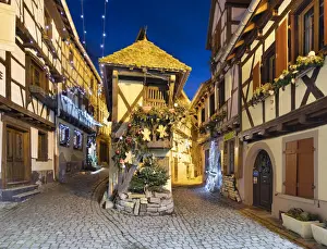 Xmas Prints: Half-timbered houses along Rue du Rempart Sud lit up with Christmas decorations at night