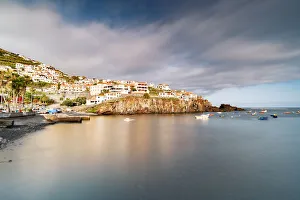Harbor of the white town Camara de Lobos perched on cliffs, Madeira island, Portugal