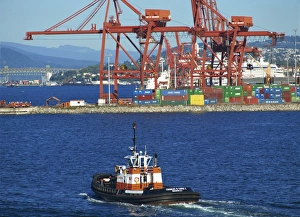 Harbour tug with containers and cranes in the background, in Vancouver Harbour tug with containers and cranes in the background, in Vancouver