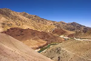 Ghor Prints: Hari Rud river flows through fertile valley at base of red rock mountains