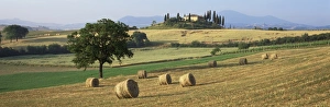 Val Dorcia Prints: Hay rolls in fields below Belvedere
