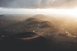 Crater Prints: Heat haze in the sky at sunrise over majestic volcanoes, Corralejo, Fuerteventura