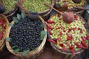 Ladle Prints: High angle view of baskets of black and green olives on a stall in the market