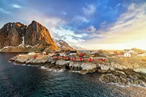 Hamnoy Prints: High angle view of majestic mountains and Hamnoy village lit by the warm light of sunrise