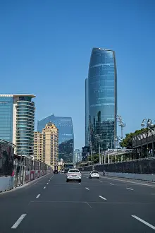 Busy Prints: High rise buildings and road in Baku, Azerbaijan with cars driving under a clear sky
