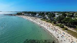 Swimming Prints: High view of Legenese cove beach with people enjoying sun and water in Brittany, France