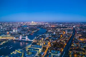 High view of London skyline at dusk along the River Thames from Tower Bridge to Canary Wharf