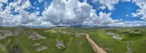 Geological Prints: Highland scenery captures open landscape with clouds and dirt path in Qarabaqh, Azerbaijan