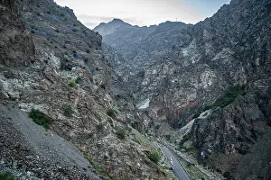 Vehicles Prints: Highway winding through rocky terrain in Mahipar pass area of Afghanistan's mountain landscape