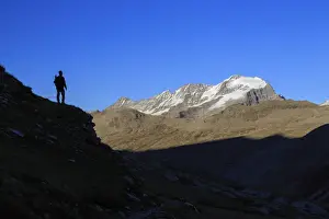 Unrecognisable Person Prints: Hiker admires the view of Alpi Graie (Graian Alps) landscape, Gran Paradiso National Park