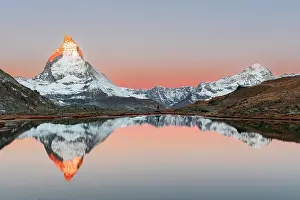 Recreational Pursuits Prints: Hiker admiring the Matterhorn reflected in the Riffelsee lake at sunrise