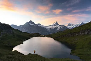 Grindelwald Prints: Hiker admiring sunrise from the shores of Bachalpsee lake, Grindelwald, Bernese Oberland