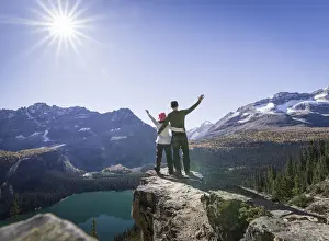 Heterosexual Couple Prints: Hiker couple at the Alpine circuit trail looking down the Lake O Hara, Yoho National Park
