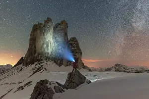 One Mature Man Only Prints: Hiker with head torch views the Tre Cime di Lavaredo on a starry night with the Milky Way